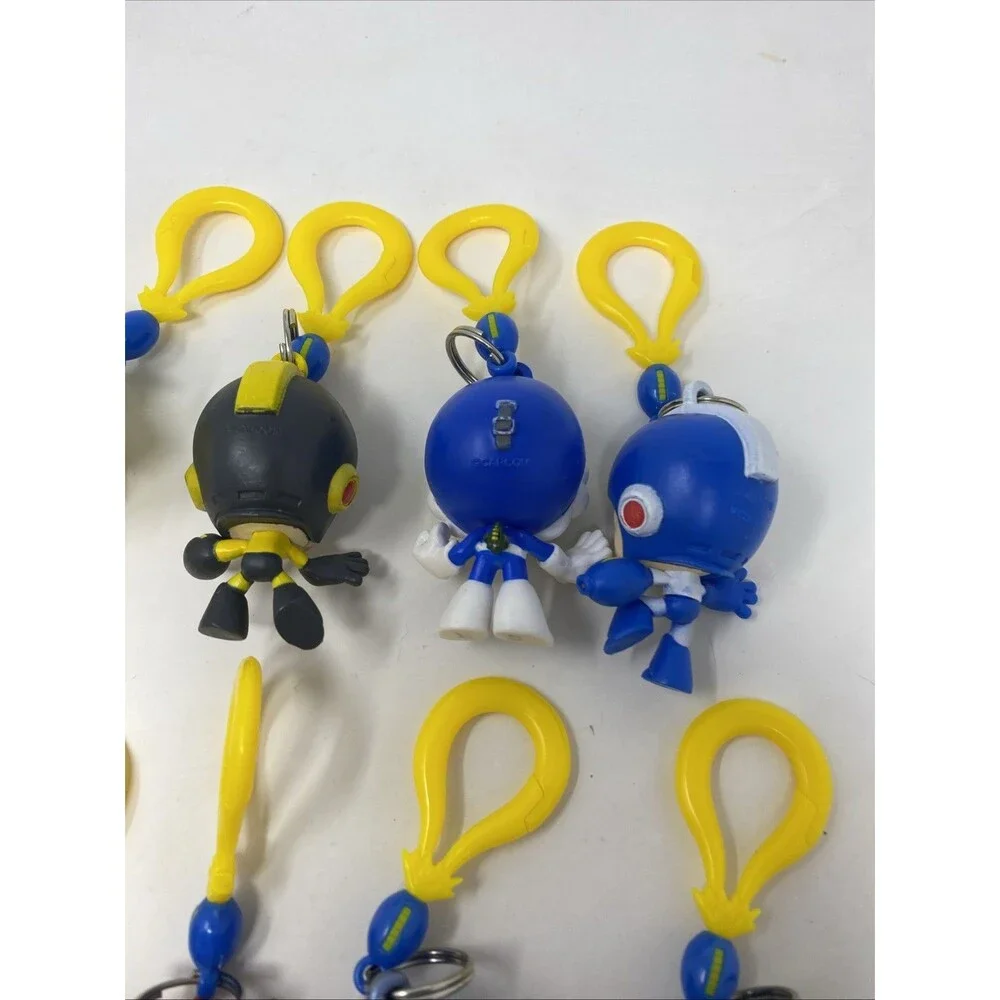 lot of 9 CAPCOM MEGA MAN BACKPACK HANGERS METALLIC FIRE MAN JUST TOYS INTL.